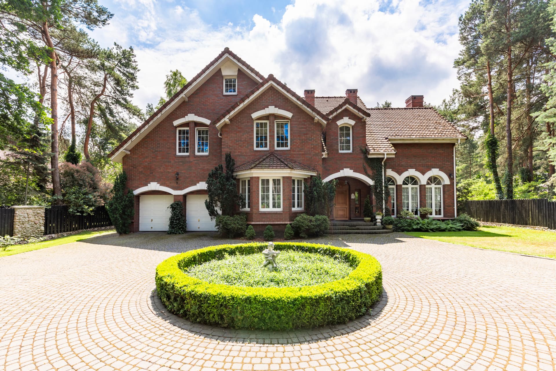 Brick Surrey house with a circular driveway and mature gardens